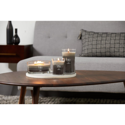 WoodWick candle staged in living room creating warm atmosphere and fragrance