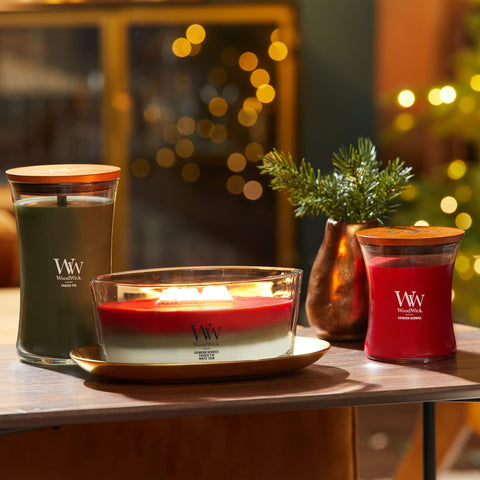 WoodWick lit candle in living room creating warm light and cozy atmosphere