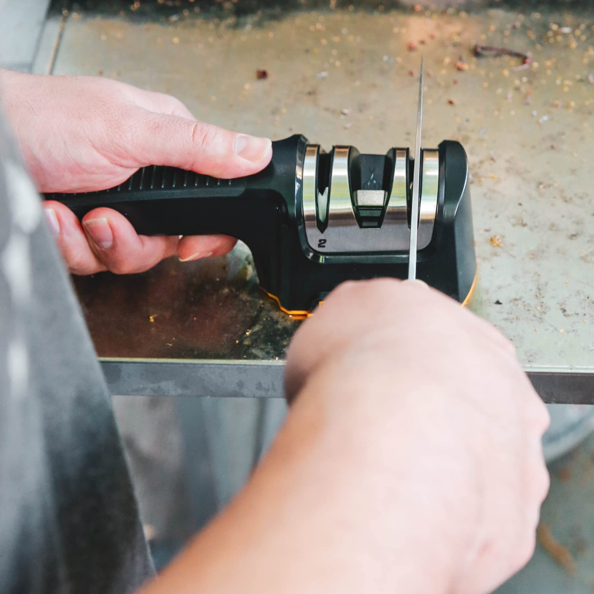 WORK SHARP being used to sharpen a kitchen knife showing easy pull-through action