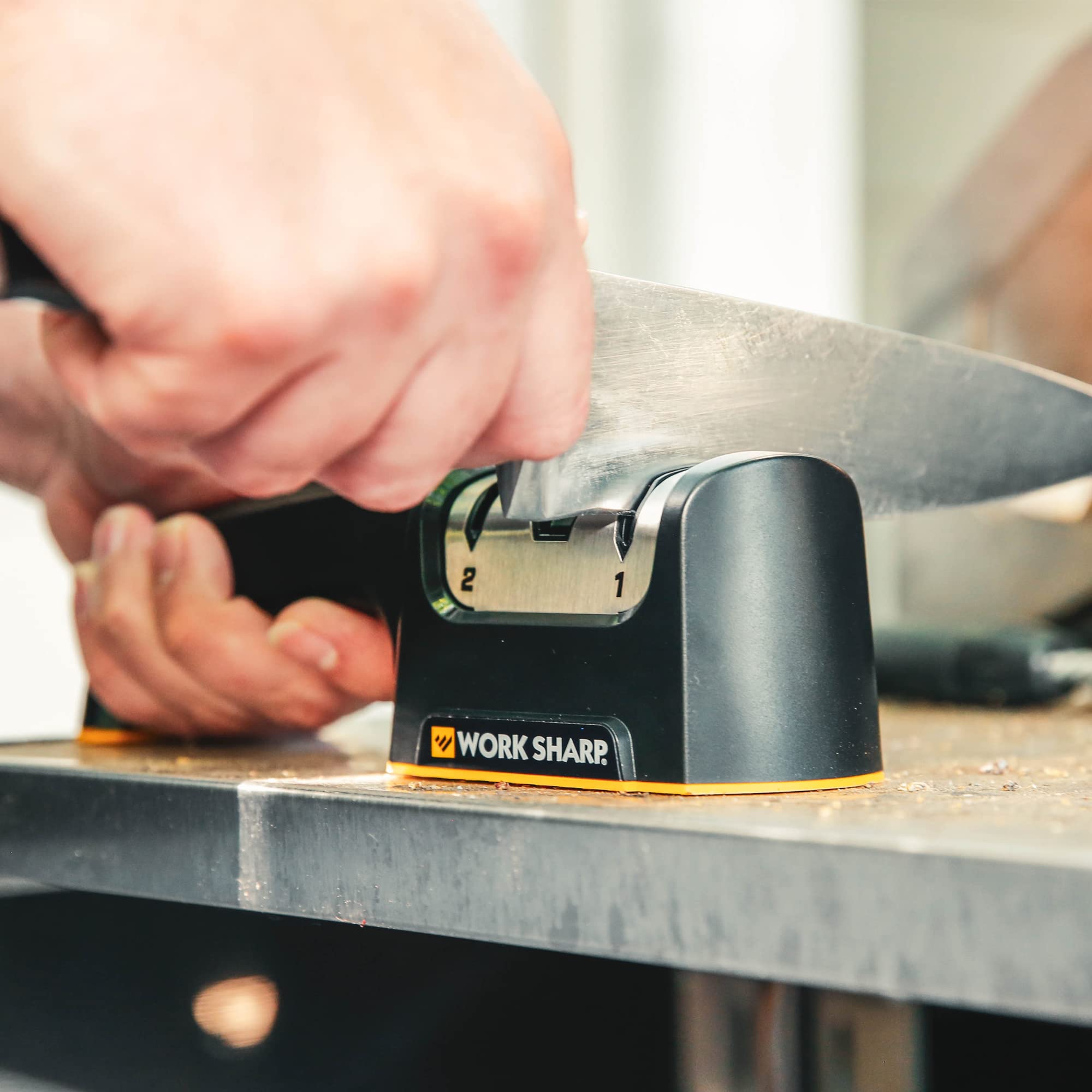 WORK SHARP next to BBQ kit illustrating portability and outdoor sharpening convenience