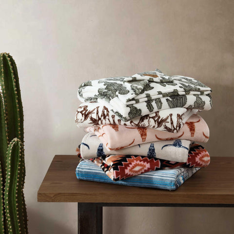 Wrangler folded throw in hands showing portability and easy storage