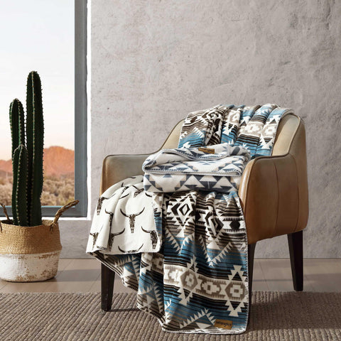 Wrangler blanket full spread on sofa showing generous coverage and comfort