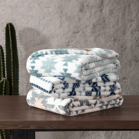 Wrangler throw layered on bed adding rustic style and soft comfort