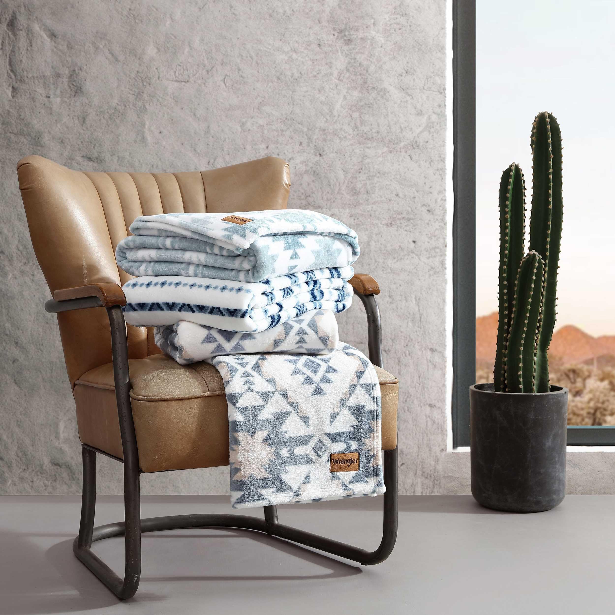 Wrangler throw beside a book showing size and easy portability