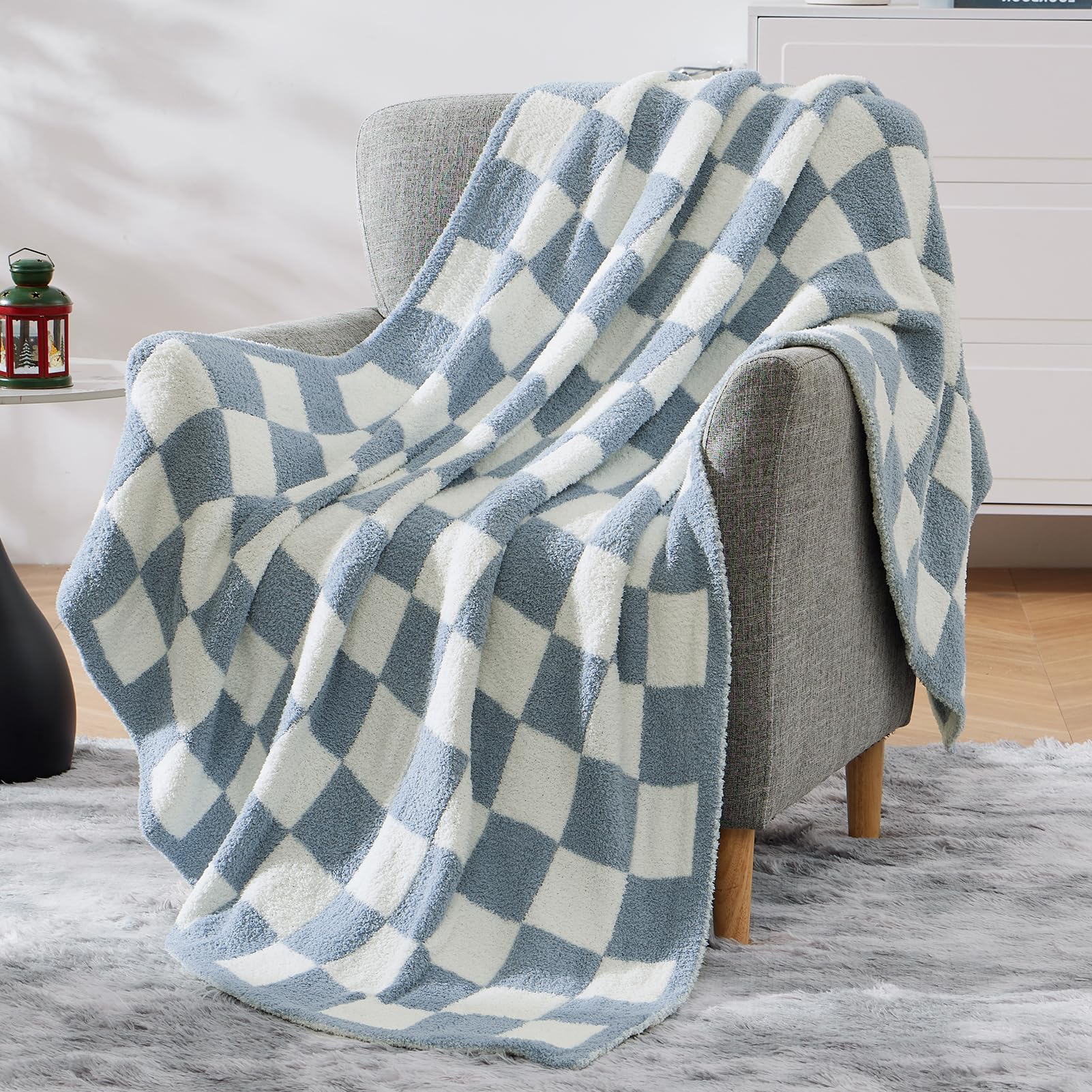 WRENSONGE blanket next to book and mug shows size and portability