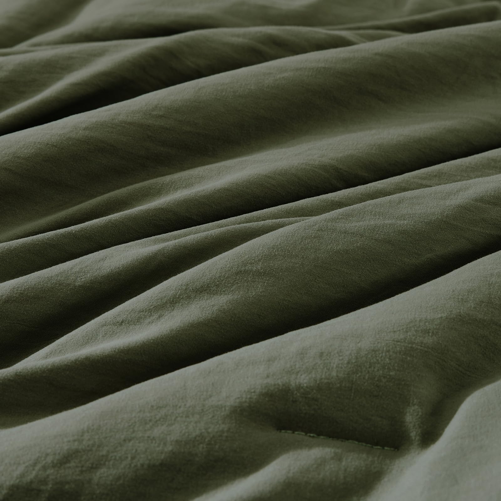 WRENSONGE comforter styled on king bed demonstrating cozy, modern bedroom appeal