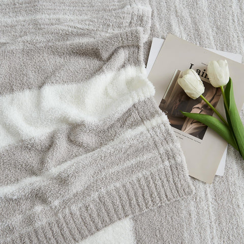 WRENSONGE draped on a couch adding style and cozy comfort to living room