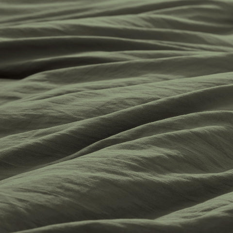 WRENSONGE styled bedroom with comforter on bed showing calming olive aesthetic