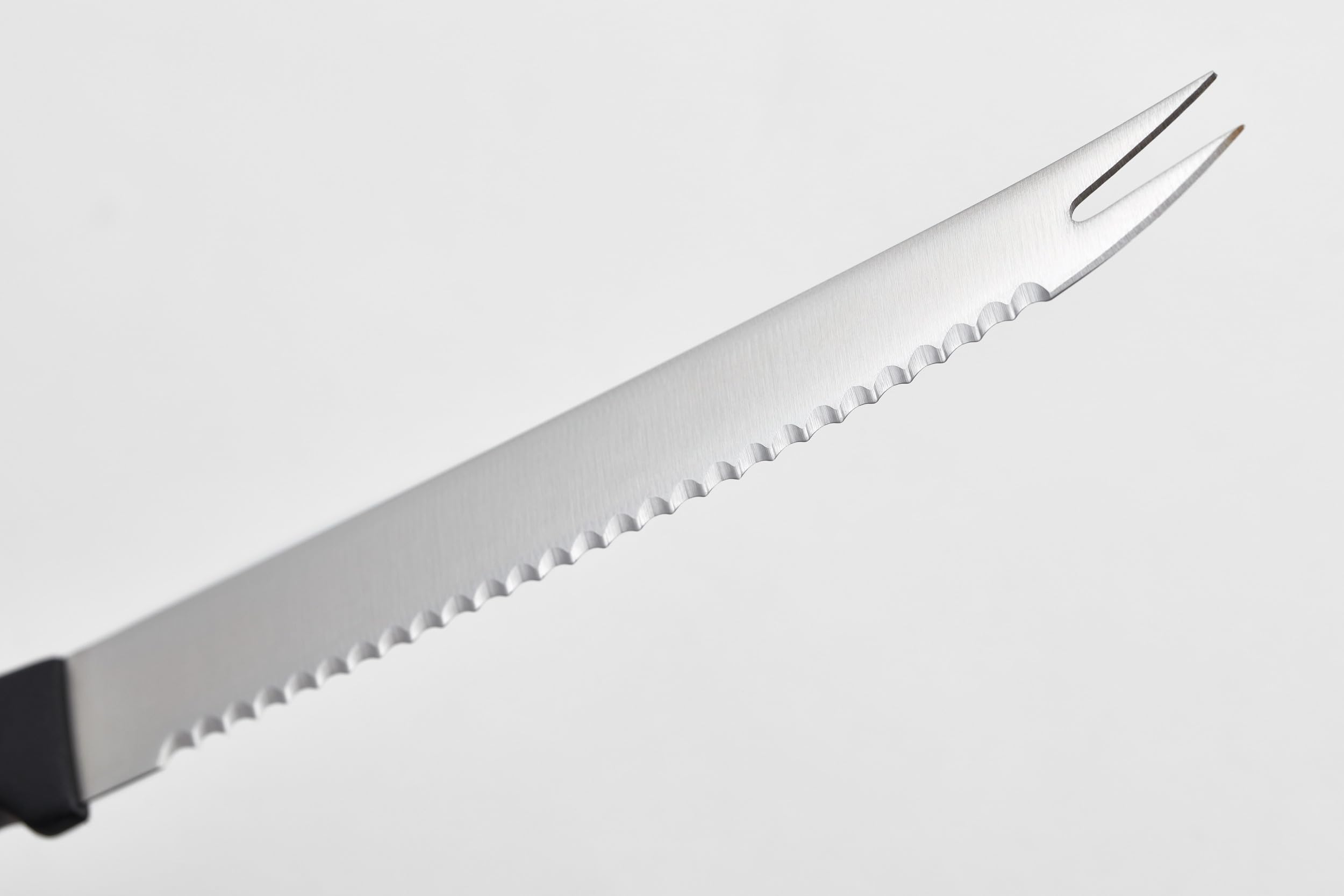 Wüsthof close-up of serrated blade highlighting clean slicing performance
