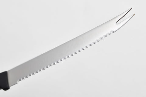 Wüsthof close-up of serrated blade highlighting clean slicing performance