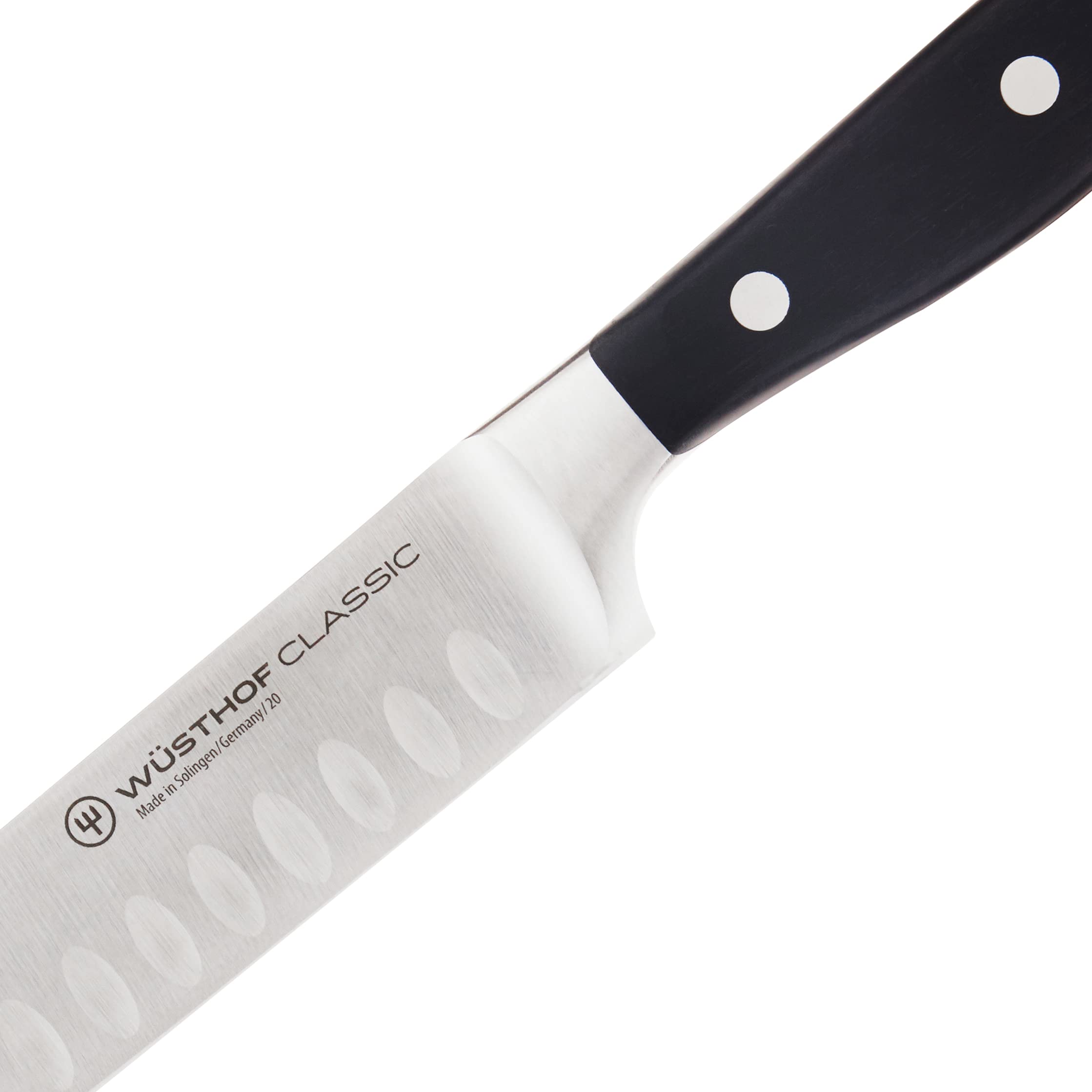 Wüsthof Classic hollow-edge blade profile close-up illustrating reduced friction and cleaner slicing