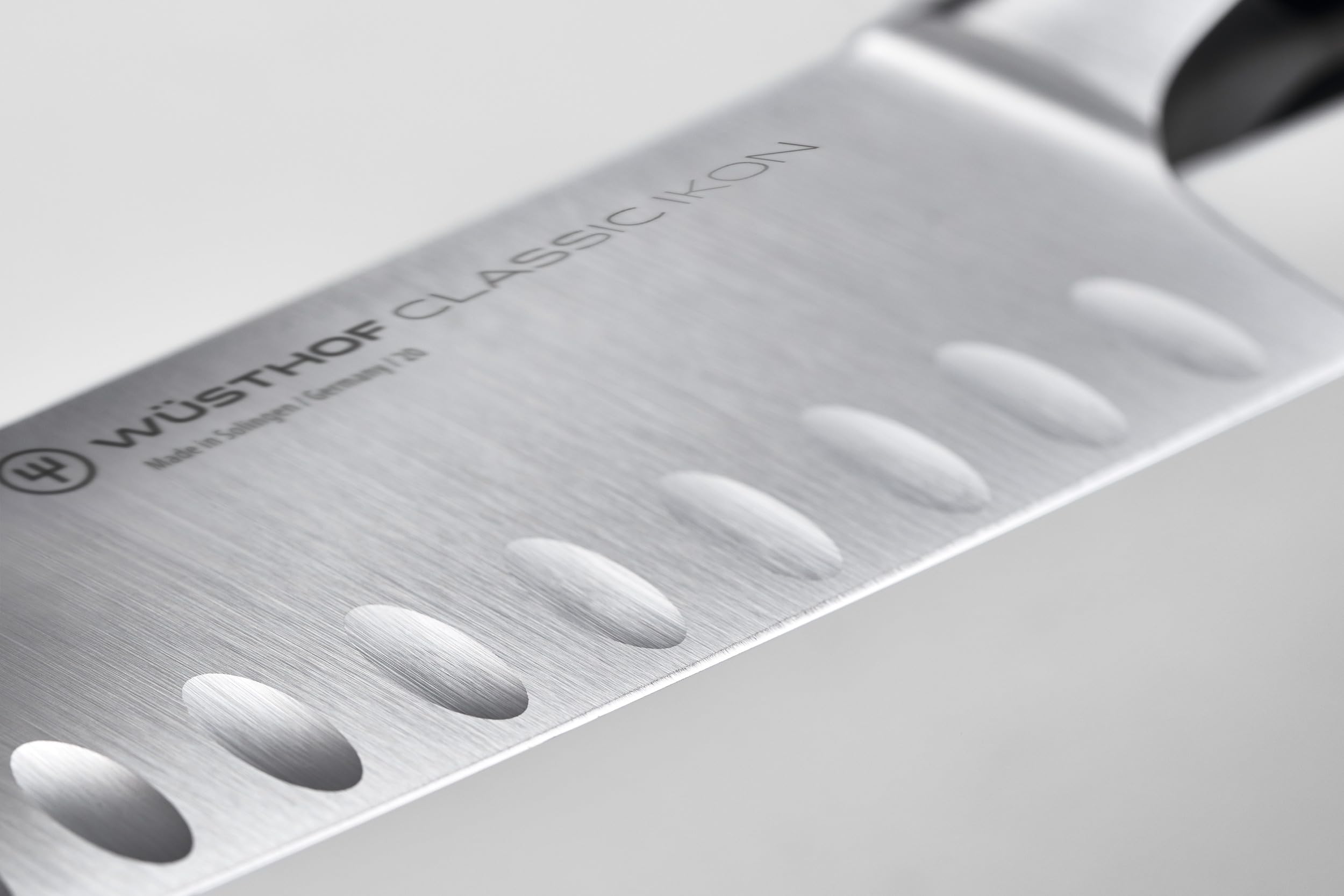 Wüsthof Classic IKON close-up of forged blade edge highlighting sharp PEtec finish and durability