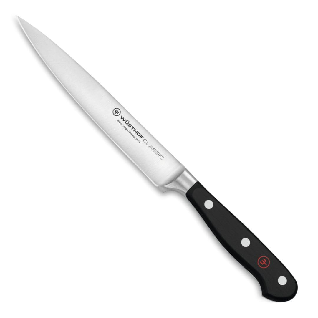 Wüsthof knives on wood cutting board demonstrating everyday use