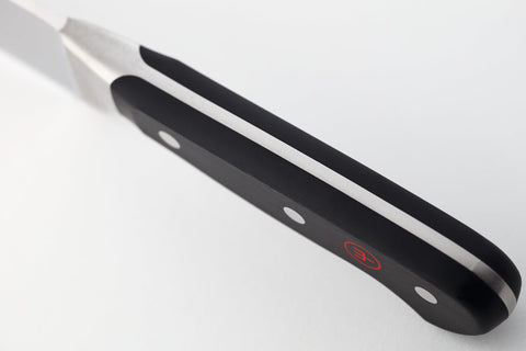 Wüsthof Classic Santoku handle detail showing triple-riveted grip for secure control