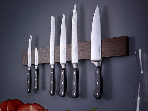 Wüsthof Classic carving knife beside ruler showing 8-inch blade for precise scale and planning