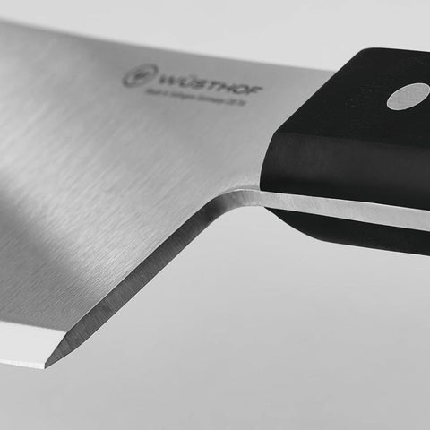 Wüsthof cleaver slicing through ribs demonstrating powerful, fatigue-reducing performance