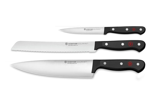 Wüsthof three-piece set front packaging showing knives and black handles, clear benefit