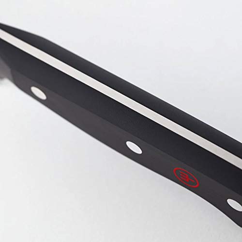 Wüsthof chef slicing crusty bread showing clean serrated cuts and ease of use