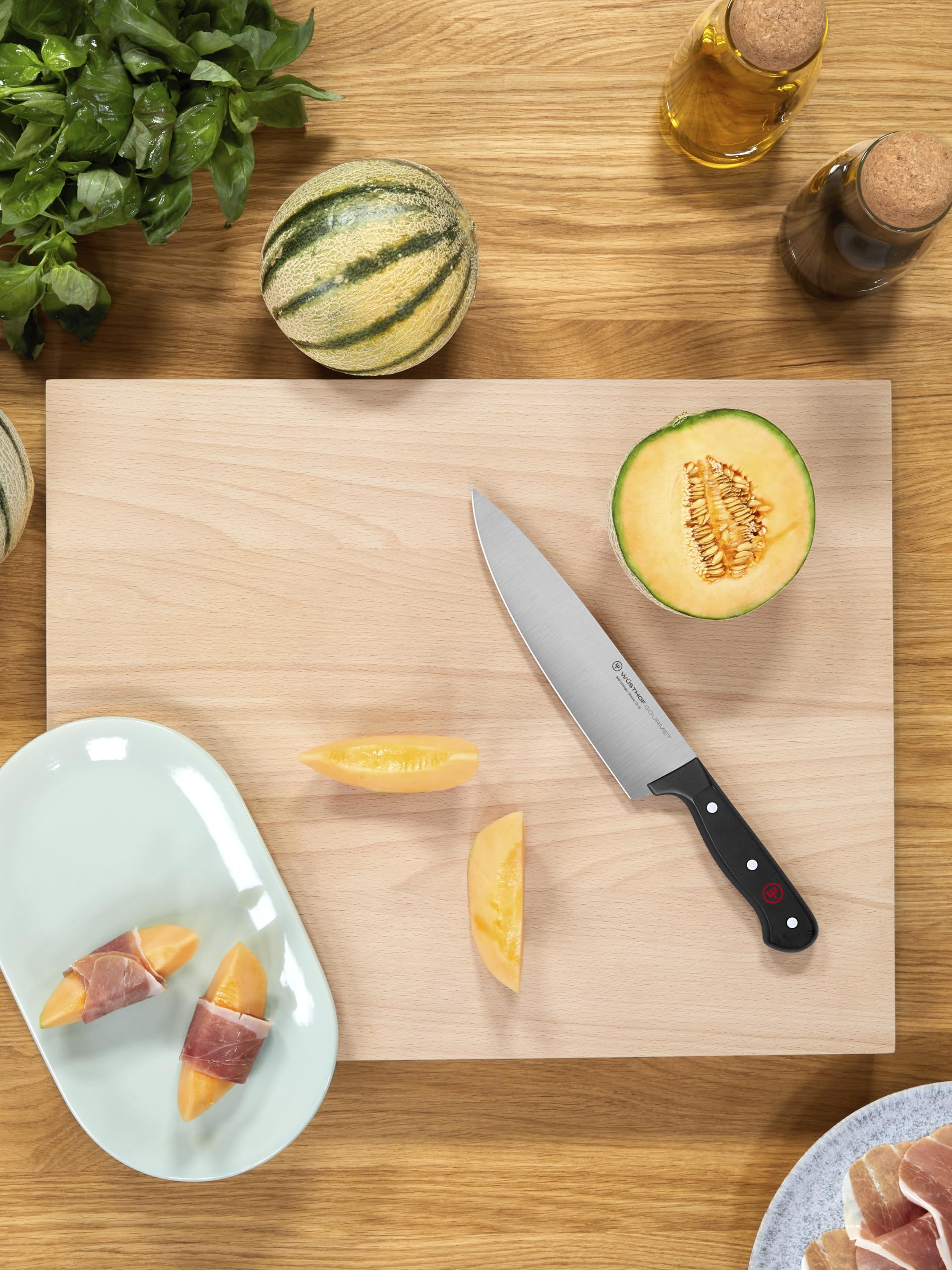 Wüsthof knife shown next to hand to demonstrate lightweight, balanced scale