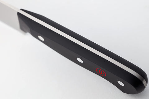 Wüsthof utility and paring knives held to show size and handling benefit