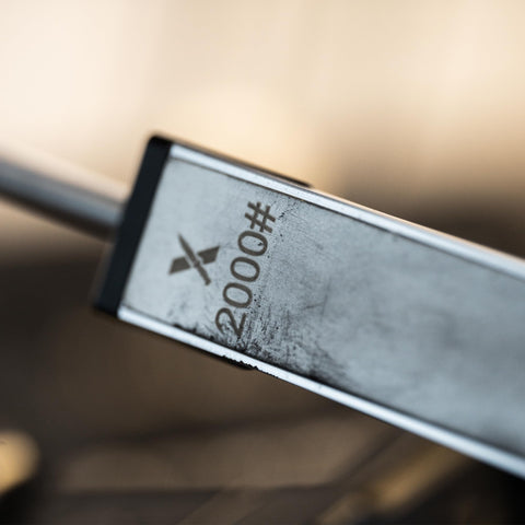XARILK sharpening a kitchen knife with guided system demonstrating controlled strokes