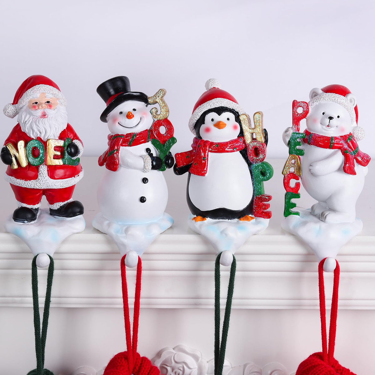 XENTUMI front view of four stocking holders showing festive set and balance
