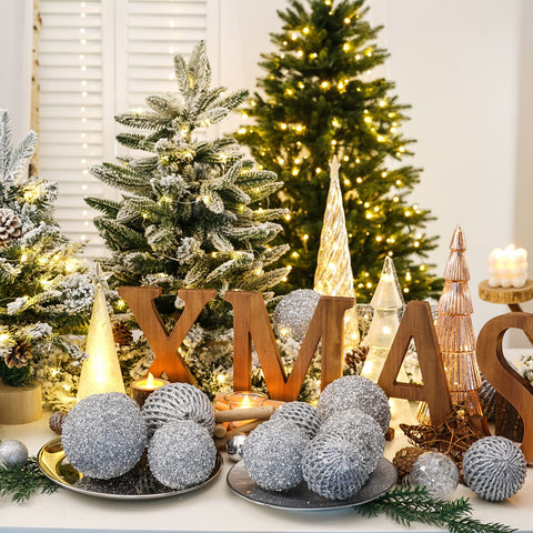 XmasExp ornament placed in a wreath adding festive shimmer to decor