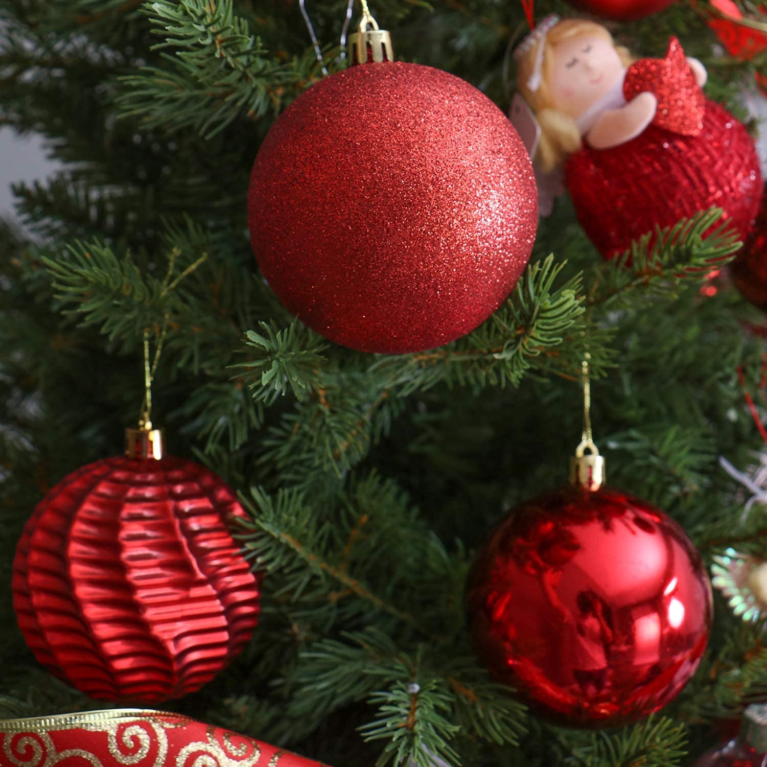 XmasExp red ornaments hung on a Christmas tree creating festive depth