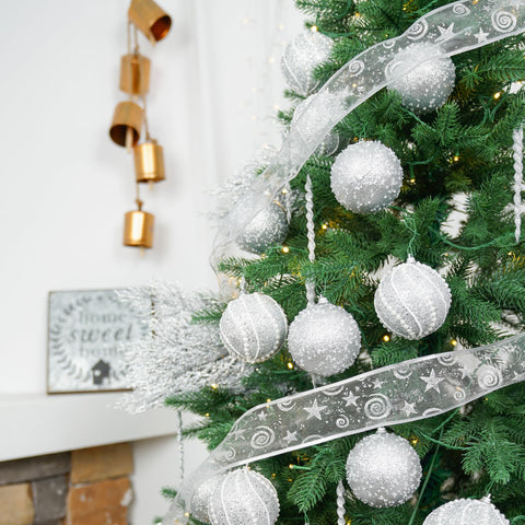 XmasExp ornament held in hand demonstrating 3.15-inch size and lightweight benefit