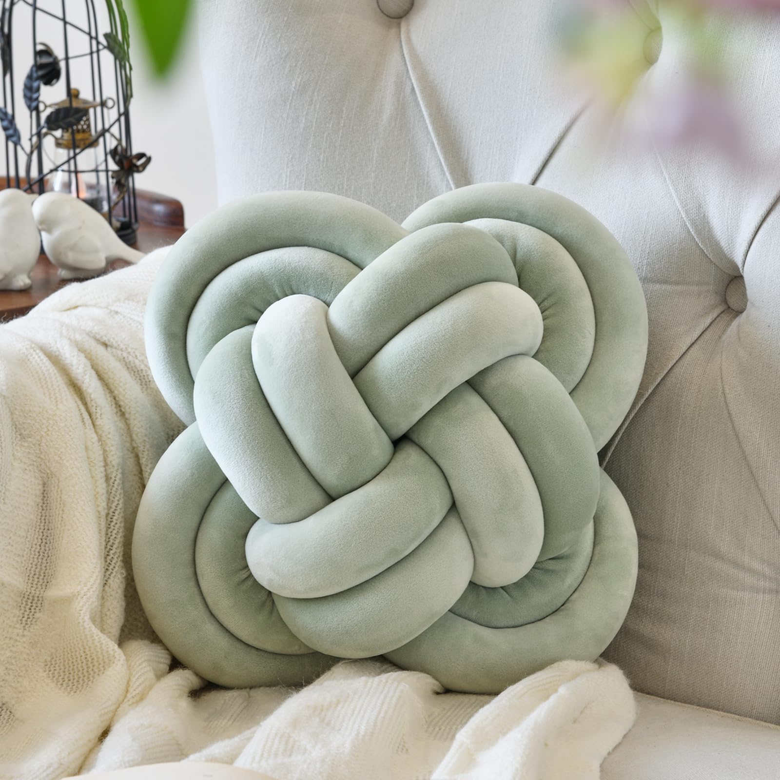 Xuyier knot pillow front view shows sage green accent and cozy appeal