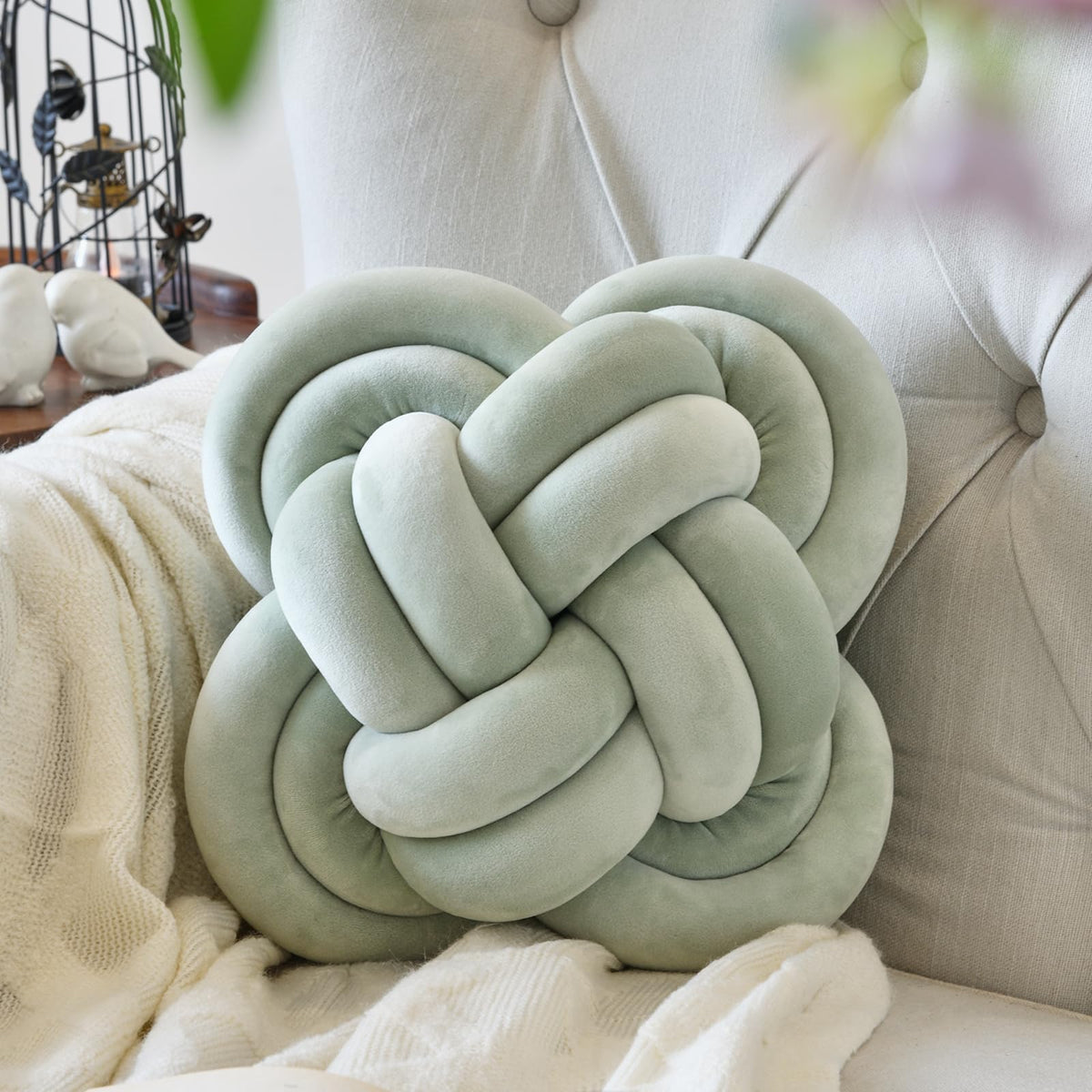 Xuyier knot pillow front view shows sage green accent and cozy appeal