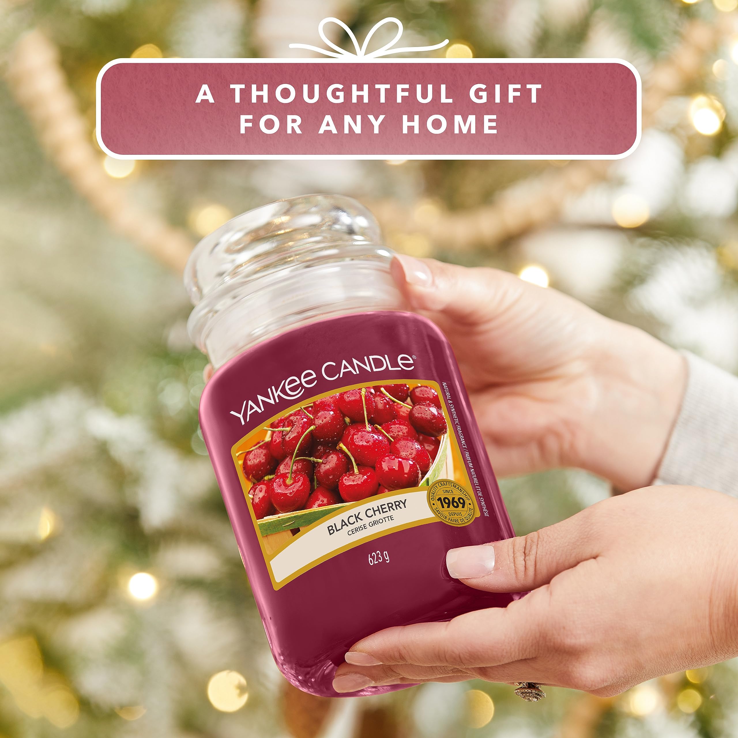 Yankee Candle black cherry beside mug demonstrates 22oz scale and ample burn time