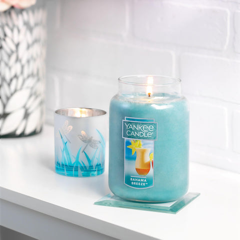 Yankee Candle Bahama Breeze beside a book showing large 22oz scale