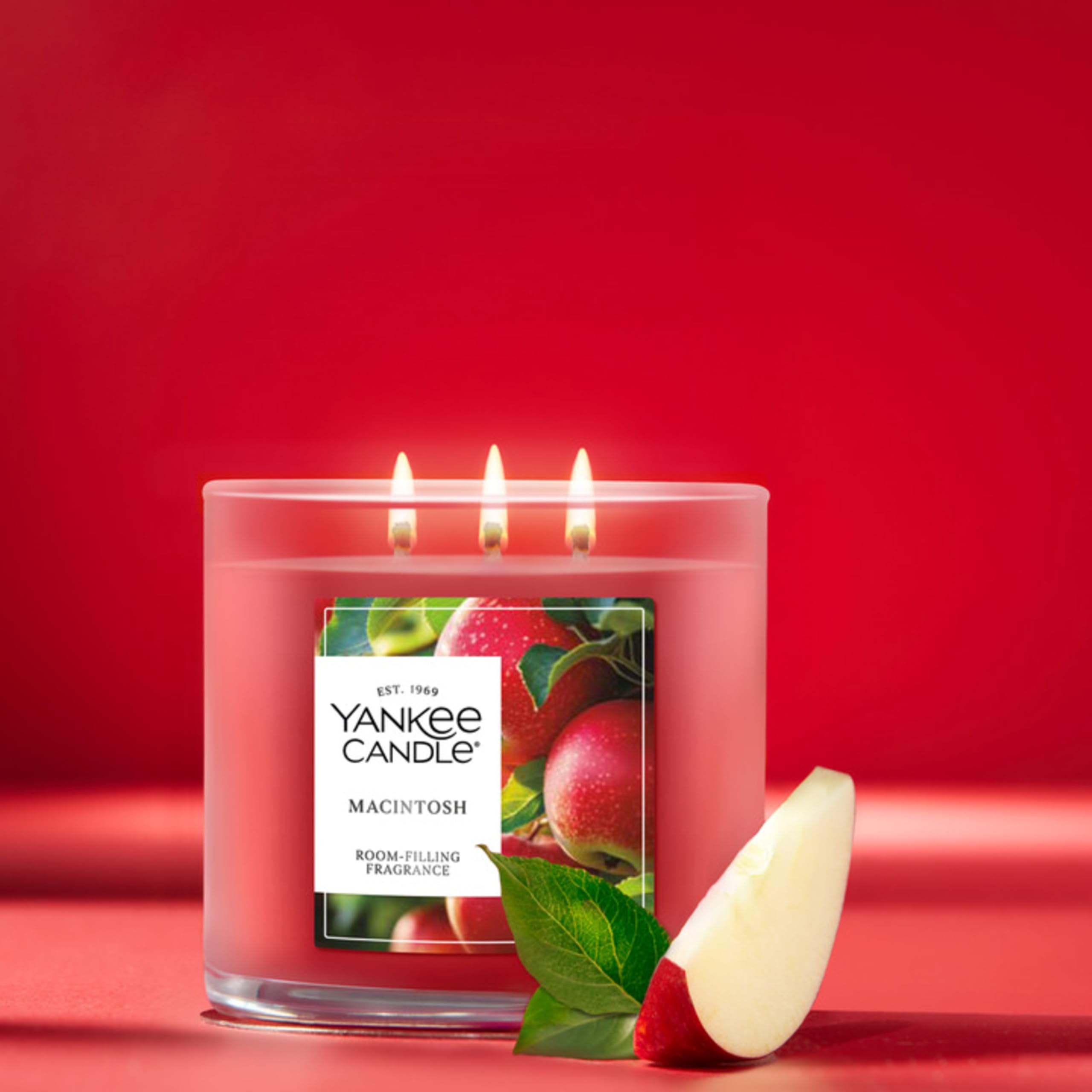 Yankee Candle Macintosh three natural-fiber wicks lit to improve fragrance throw