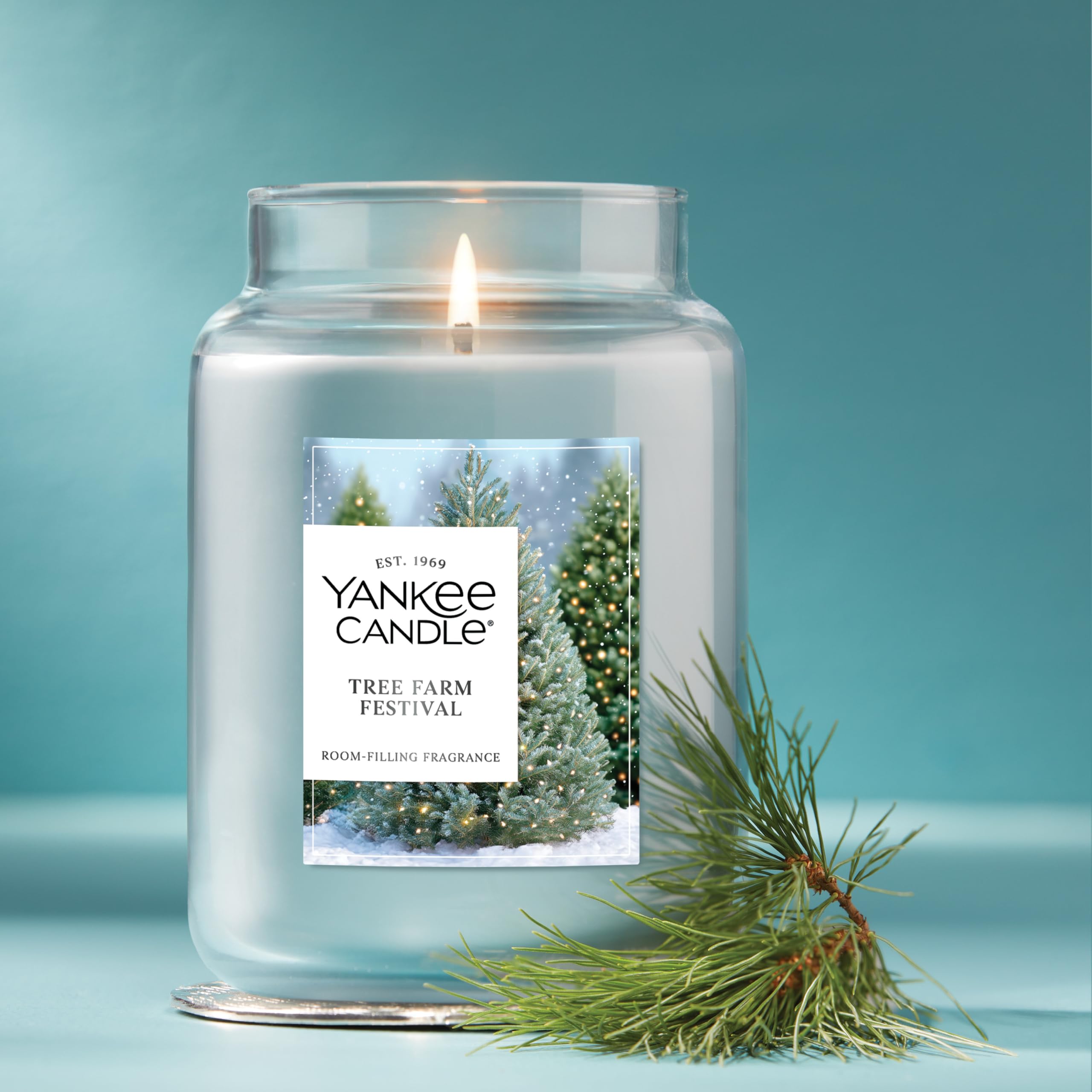 Yankee Candle lit jar in living room offering cozy holiday aroma throughout space