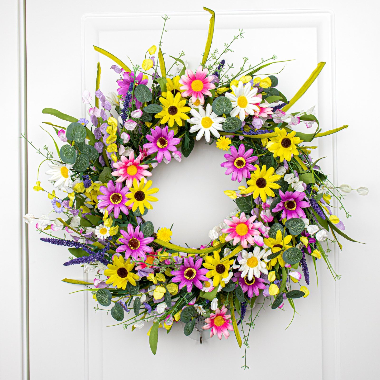 Yawwind wreath displayed on a window sill brightening indoor space