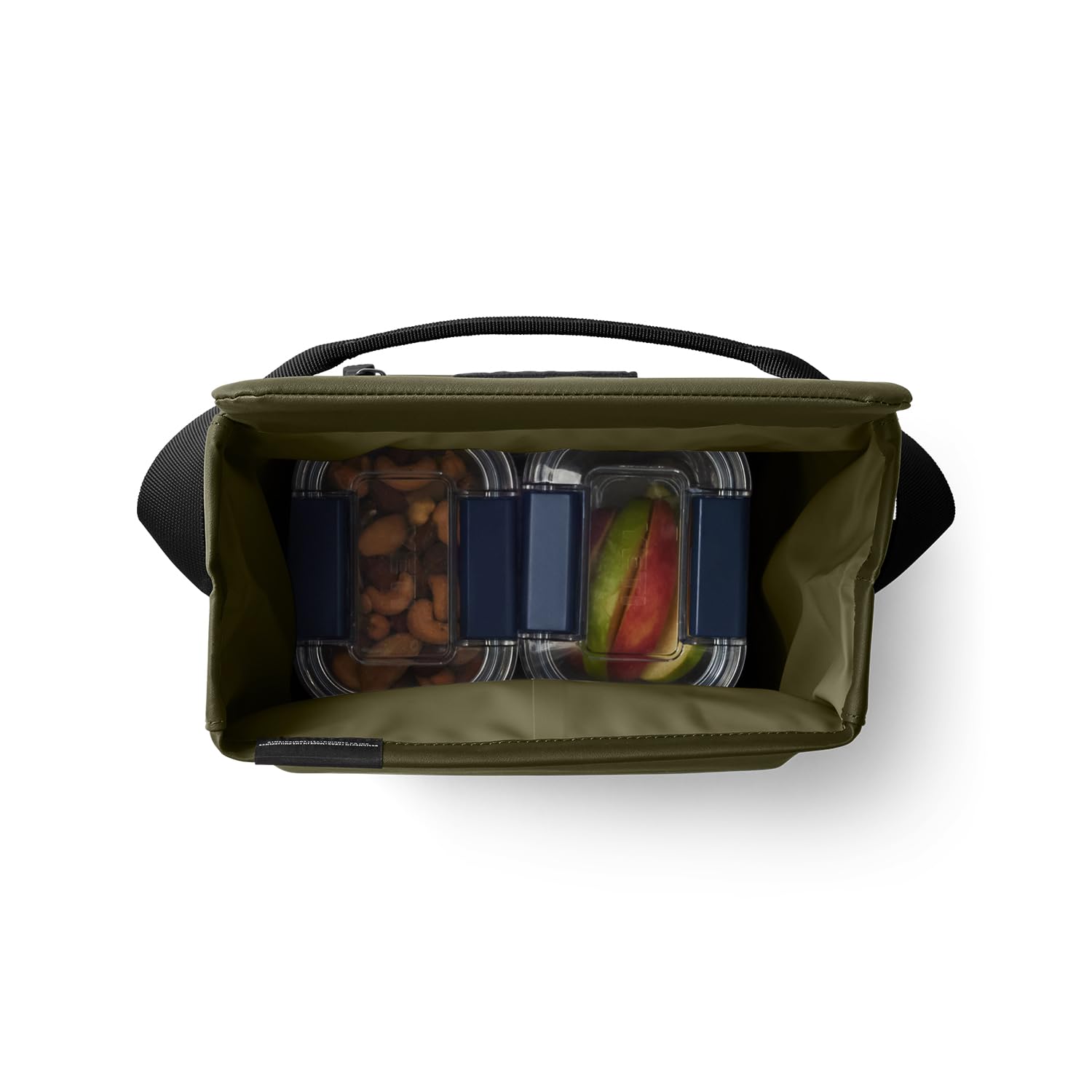 YETI Daytrip 6L olive on picnic blanket showing rugged outdoor-ready benefit