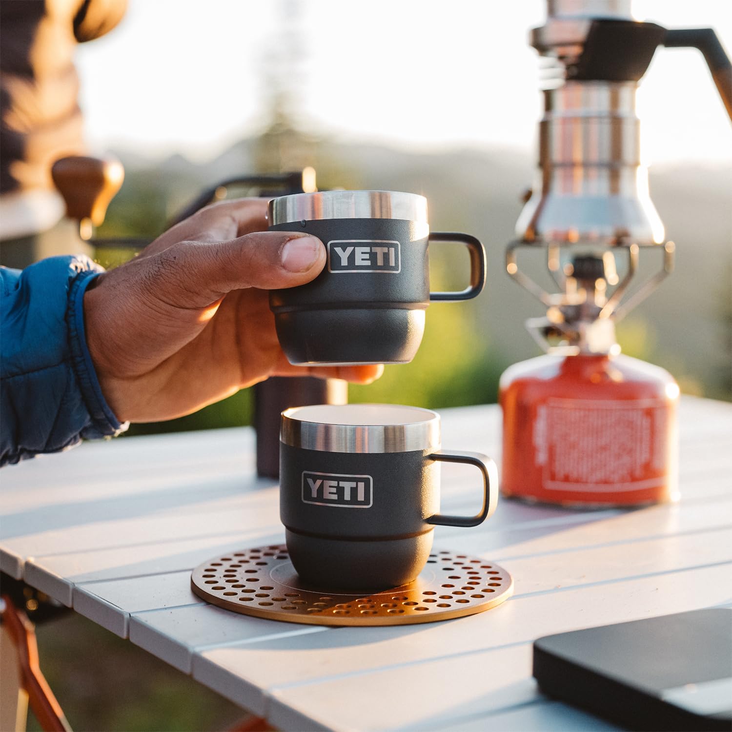 YETI Rambler 6 oz on a camp table in Rescue Red highlighting rugged outdoor usability