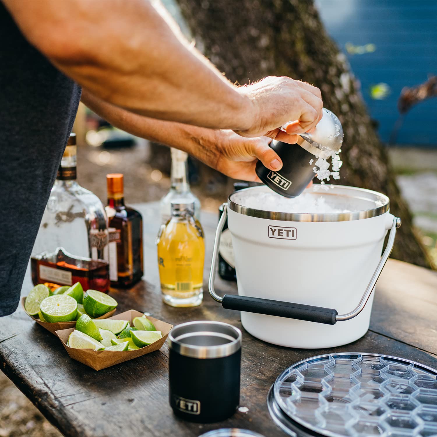 YETI Rambler beverage bucket beside six-pack to show scale and large capacity