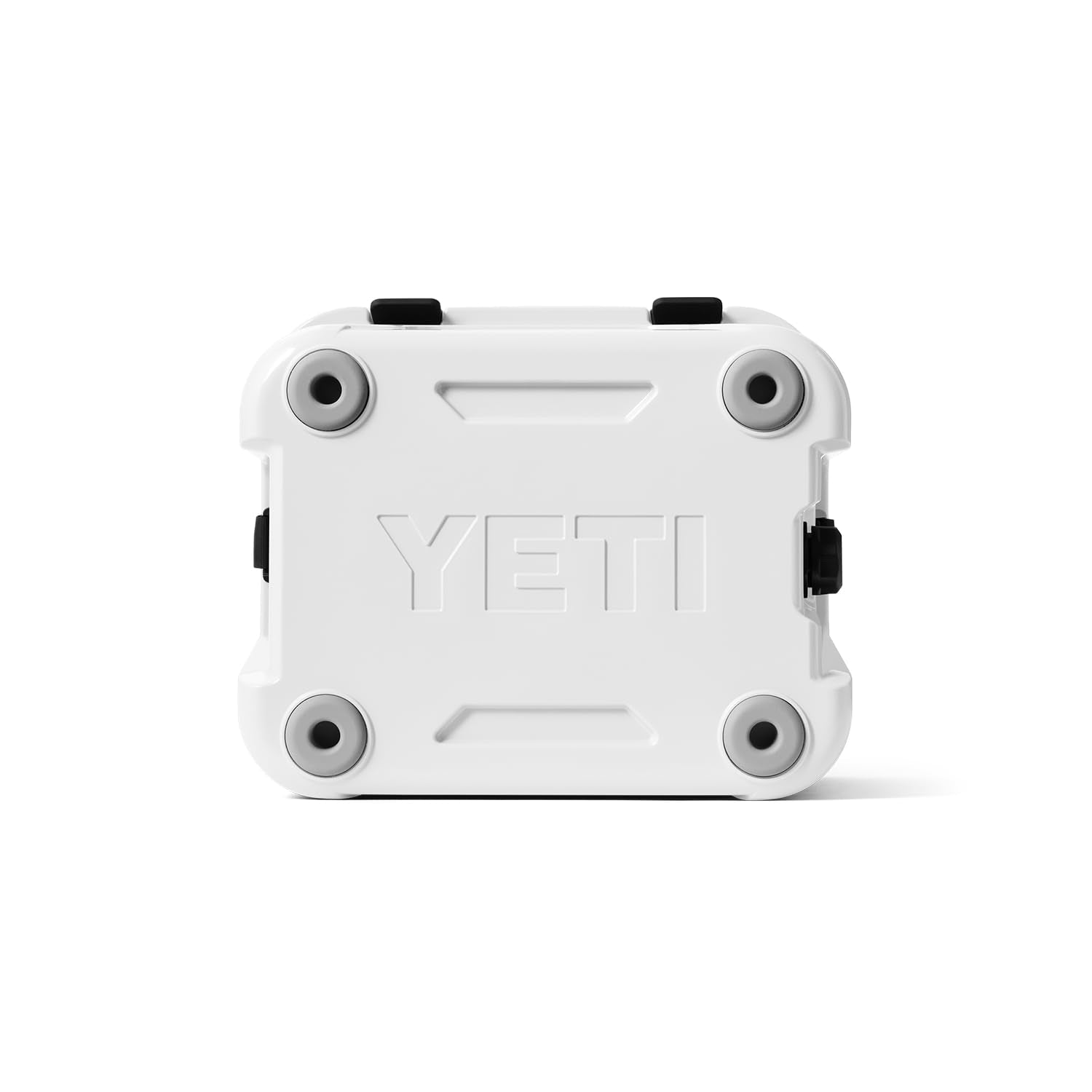 YETI Roadie 24 beside backpack showing compact scale and travel readiness