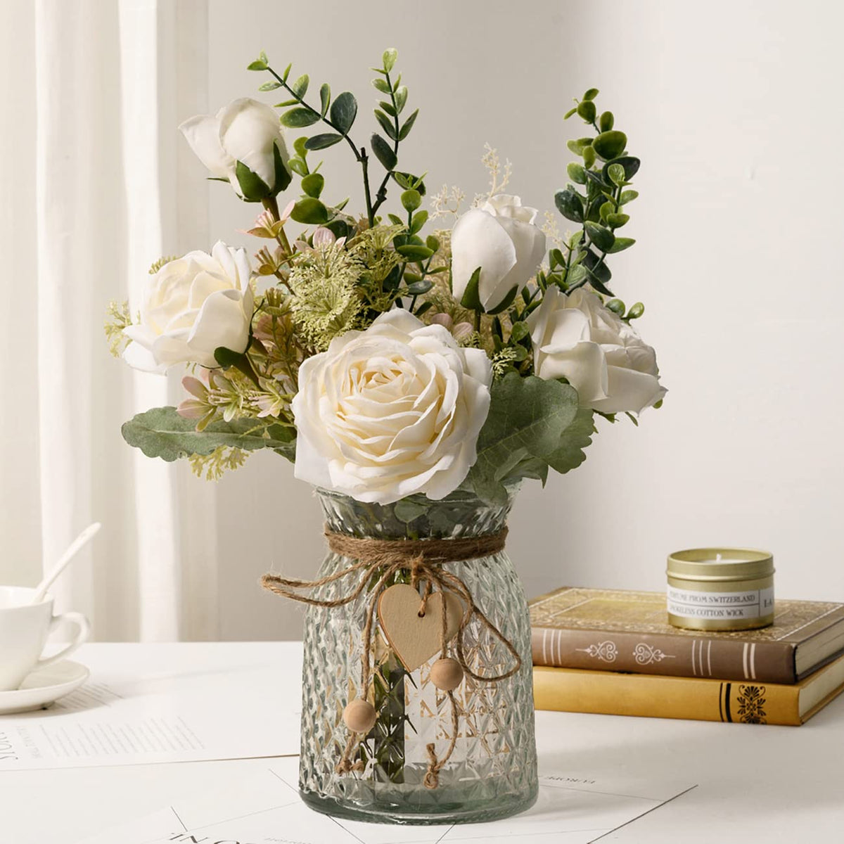 YJ front view of white rose arrangement in glass vase brightening a table