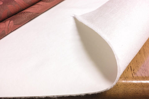 Yourtablecloth front view of 52x140 pad showing white vinyl surface and benefit of spill protection