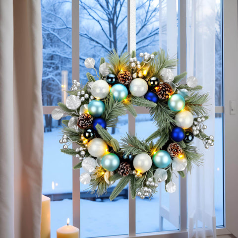 YULETIME pre-lit wreath on front door glowing with warm white LEDs