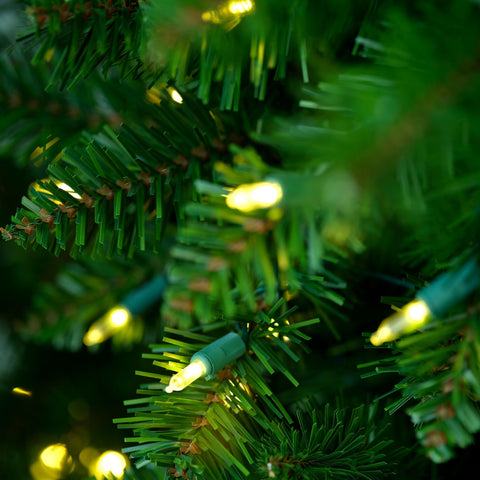 YULETIME tree next to chair for scale illustrating the 6.5 ft height