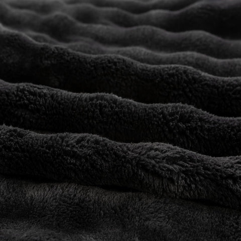 YUSOKI blanket held in hands showing lightweight portability benefit