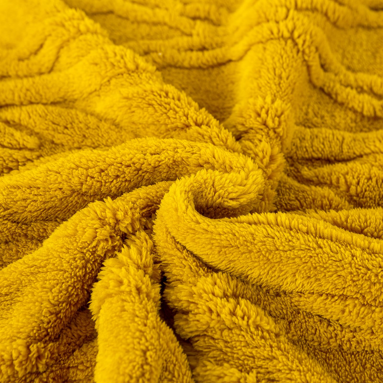 YUSOKI throw styled on bed showing room-enhancing warmth and color