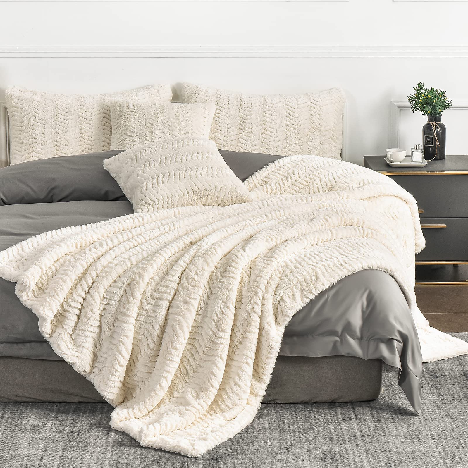 YUSOKI blanket laid at foot of bed for layered styling and added warmth