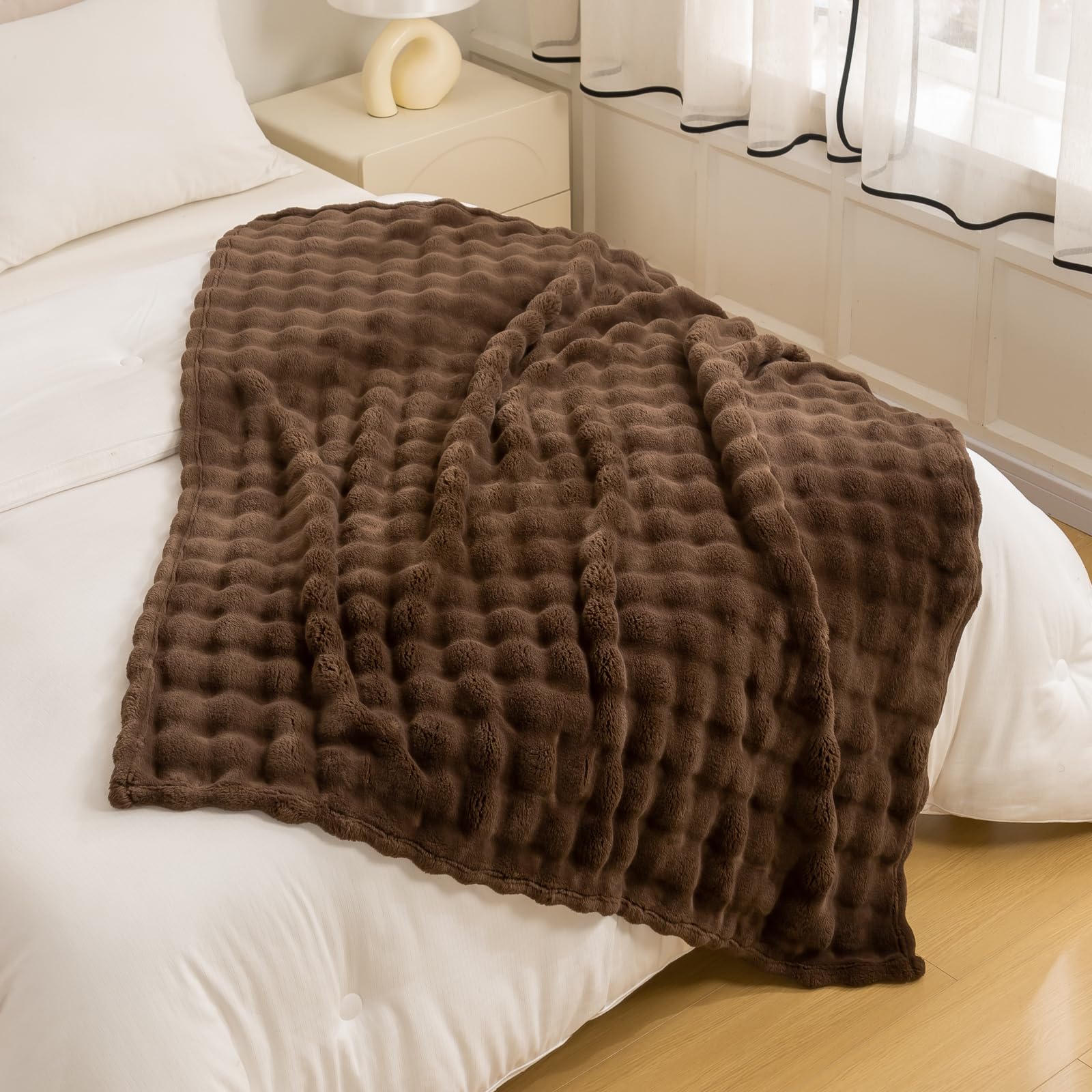 YUSOKI layered on bed to add texture and lightweight warmth to bedroom