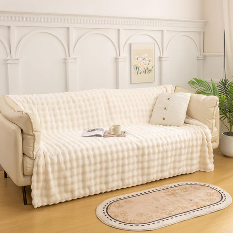 YUSOKI draped over sofa adding visual depth and cozy comfort to living room