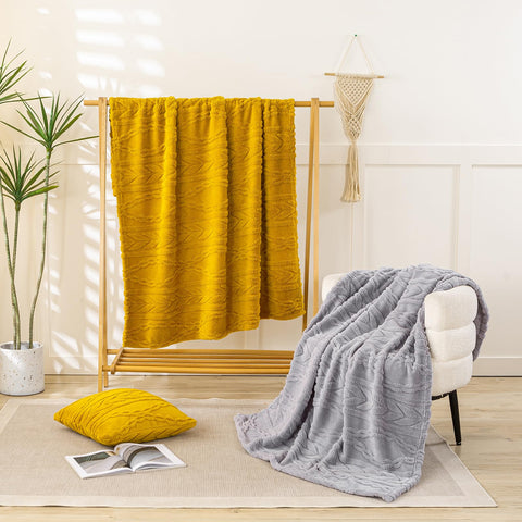 YUSOKI folded blanket next to ruler showing oversized 50x65 scale benefit
